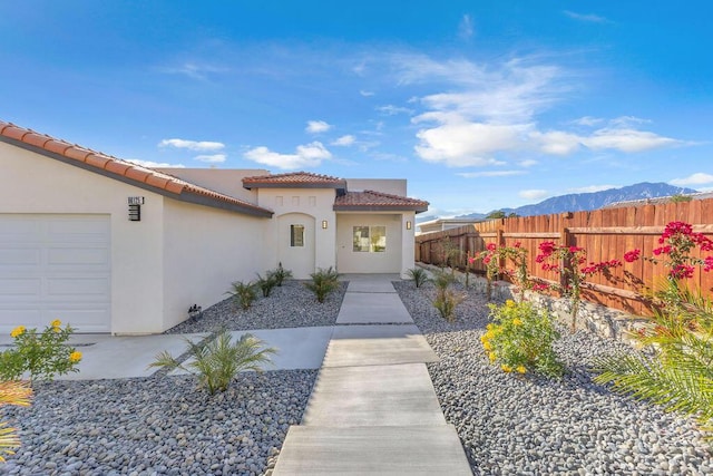 doorway to property with a mountain view and a garage