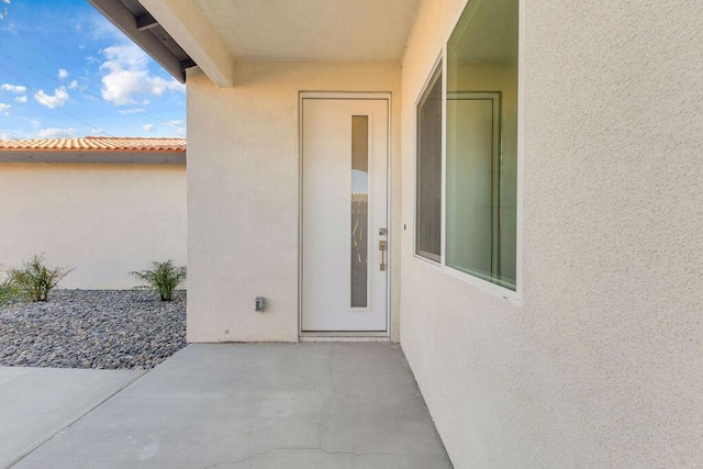 property entrance with a patio area