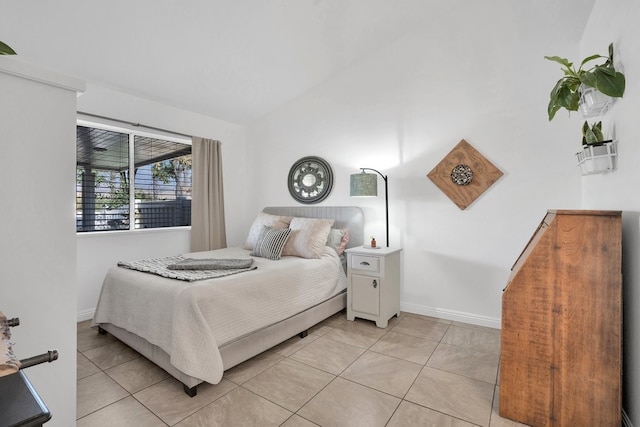 bedroom featuring light tile patterned floors and lofted ceiling