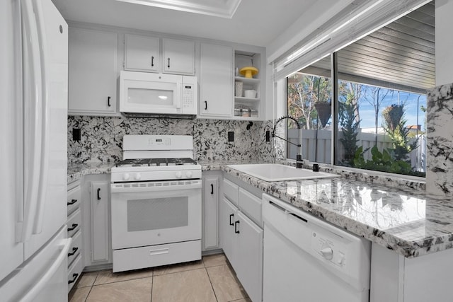 6141 Wingfoot Ave, Banning, CA 92220 - kitchen with white appliances, white cabinets, backsplash, light tile patterned flooring, and open shelves