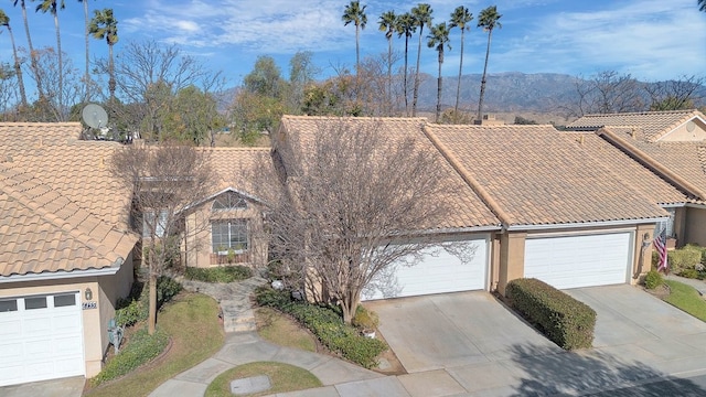 6141 Wingfoot Ave, Banning, CA 92220 - view of front of home with a tile roof, concrete driveway, stucco siding, and an attached garage
