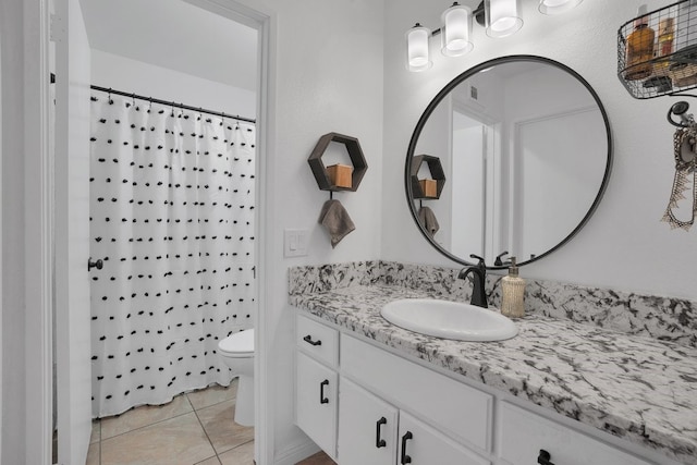 bathroom with tile patterned flooring, vanity, curtained shower, and toilet