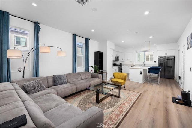 living room with light hardwood / wood-style flooring