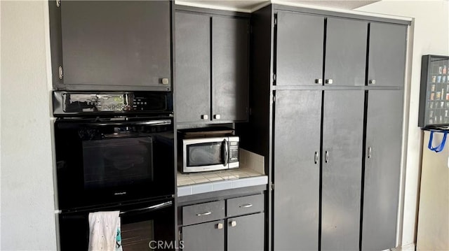 kitchen featuring tile countertops, gray cabinets, and double oven