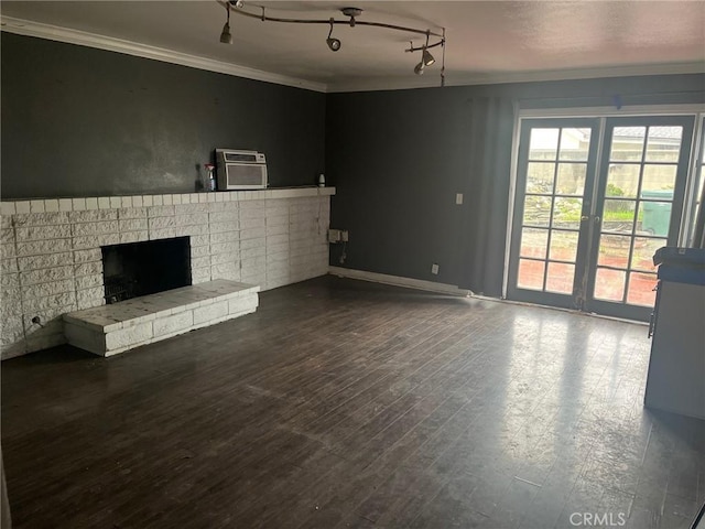7002 Valentine Dr, Huntington Beach, CA 92647 - unfurnished living room featuring dark wood-style floors, a fireplace, ornamental molding, an AC wall unit, and track lighting