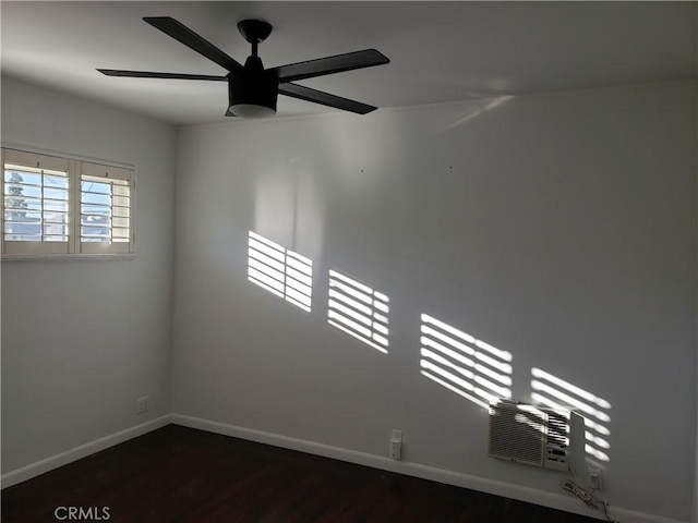 spare room featuring ceiling fan and dark hardwood / wood-style floors