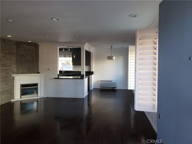 unfurnished living room featuring sink