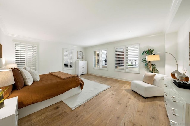 bedroom featuring light wood-type flooring and ornamental molding