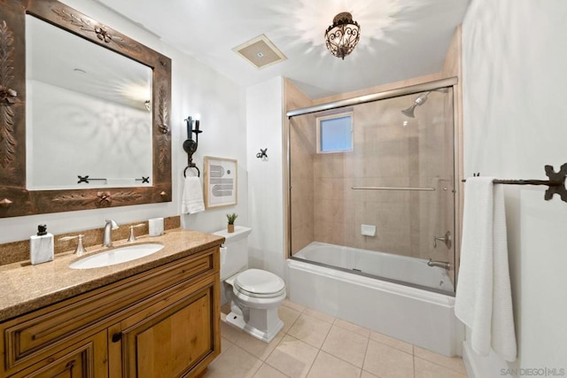 full bathroom featuring tile patterned floors, vanity, enclosed tub / shower combo, and toilet