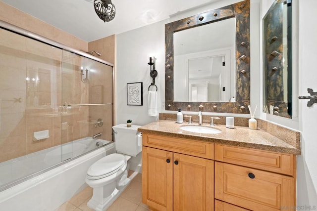 full bathroom featuring tile patterned flooring, vanity, combined bath / shower with glass door, and toilet