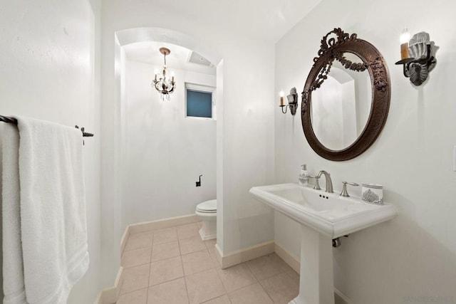 bathroom with tile patterned flooring, toilet, and sink