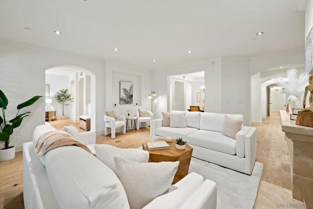 living room with light wood-type flooring and crown molding