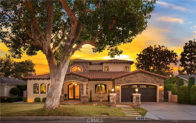 view of front of property featuring a garage and a yard