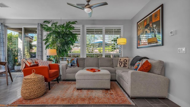 living room with tile patterned floors, a wealth of natural light, and ceiling fan