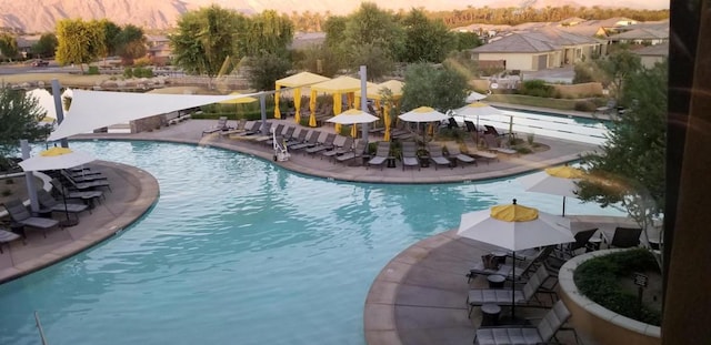 view of pool at dusk