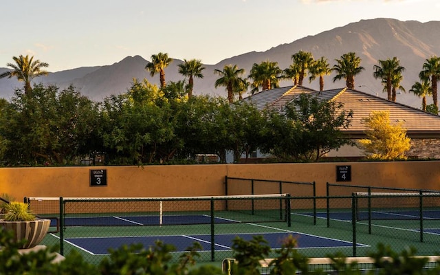 view of tennis court with a mountain view