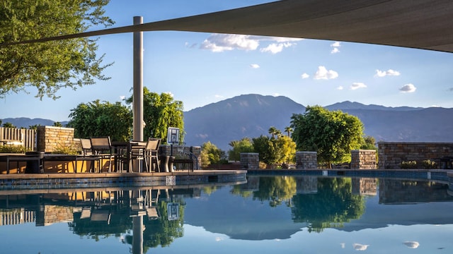 view of pool with a water and mountain view