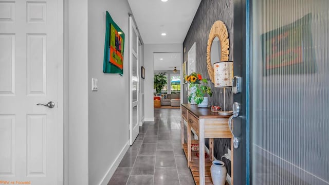 hall with dark tile patterned floors