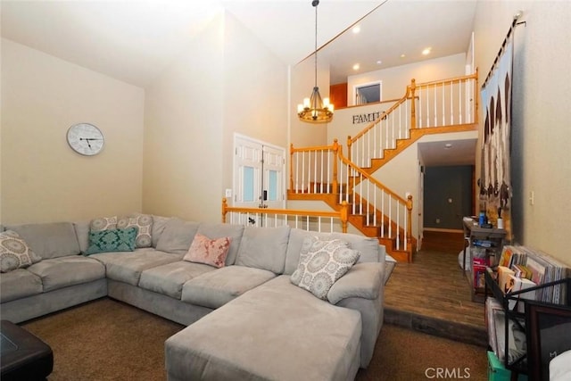 living room featuring high vaulted ceiling, dark hardwood / wood-style floors, and a notable chandelier