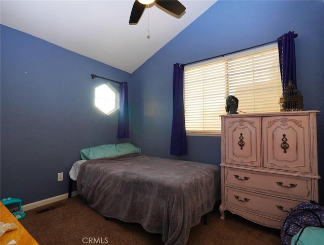 bedroom with ceiling fan, lofted ceiling, and dark colored carpet