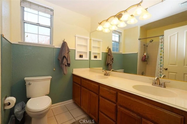 bathroom featuring tile patterned floors, vanity, toilet, and a wealth of natural light