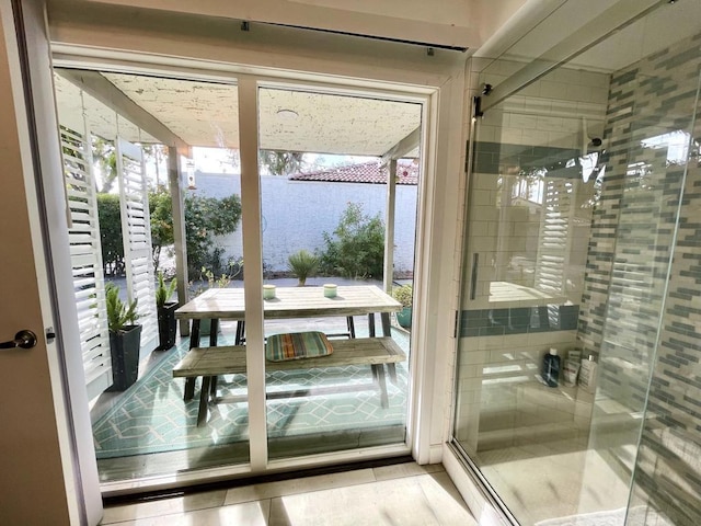 doorway to outside featuring tile patterned floors