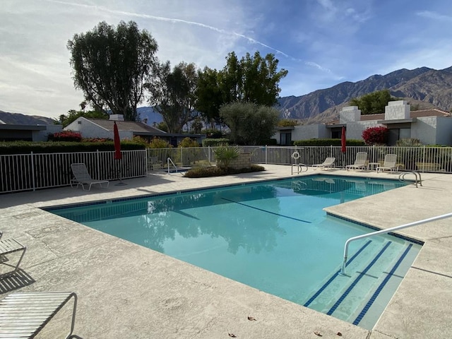 view of swimming pool featuring a mountain view and a patio area