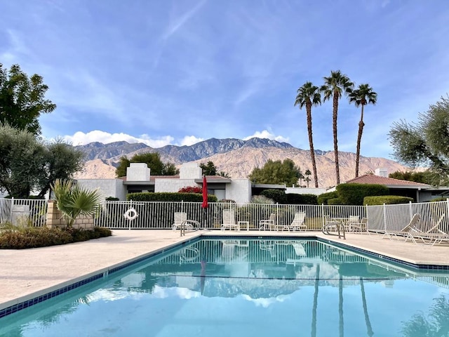 view of swimming pool featuring a patio area and a mountain view