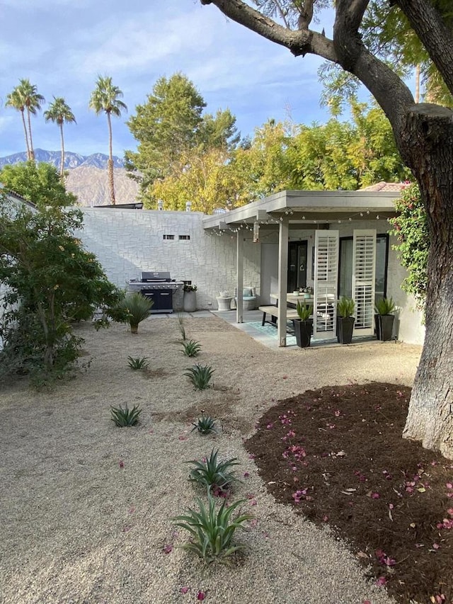 exterior space with a mountain view and a patio