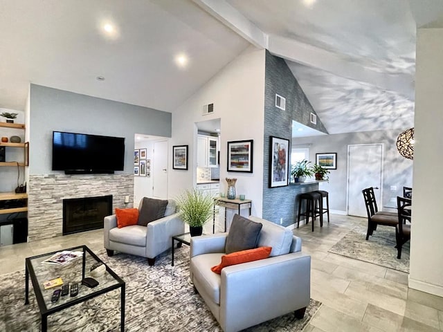 living room featuring high vaulted ceiling, a tile fireplace, and beamed ceiling