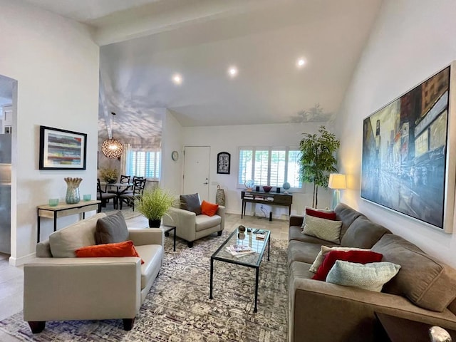 living room with lofted ceiling and a notable chandelier