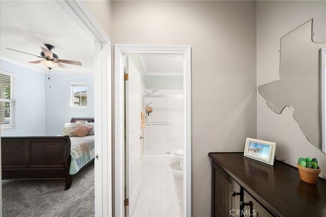 bathroom featuring walk in shower, ceiling fan, toilet, and ornamental molding