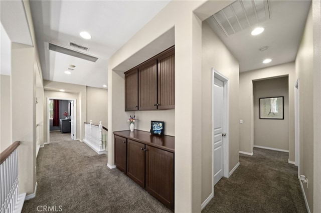 corridor with dark colored carpet