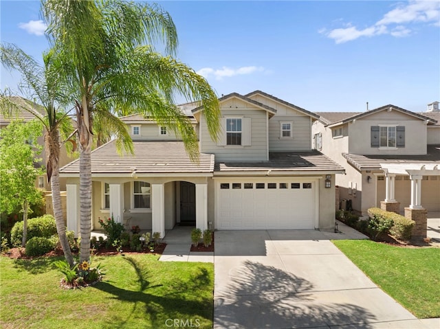 view of front of home featuring a front yard and a garage