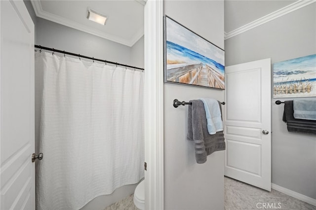 bathroom with toilet and ornamental molding