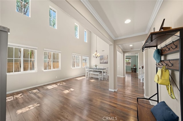 interior space with a chandelier, dark hardwood / wood-style flooring, and crown molding