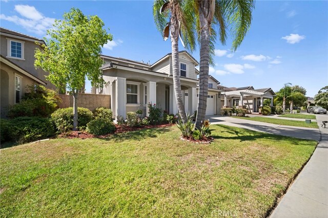 view of front of property featuring a garage and a front yard