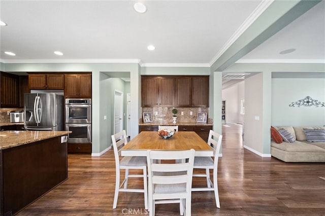 kitchen with decorative backsplash, a kitchen breakfast bar, wooden counters, stainless steel appliances, and dark wood-type flooring