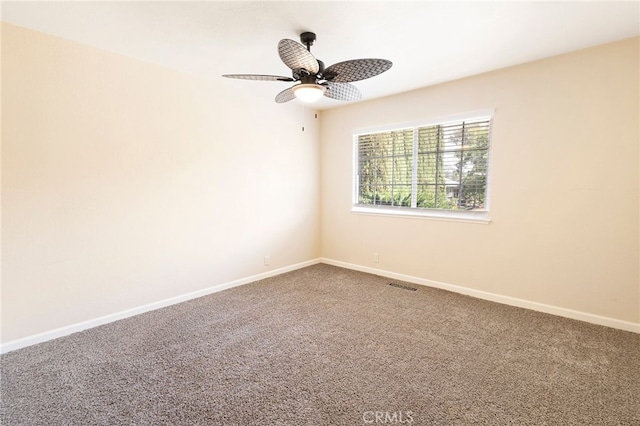 empty room with ceiling fan and carpet flooring