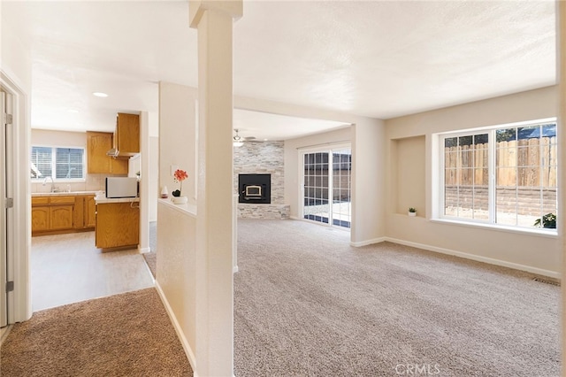 hallway with light colored carpet and sink