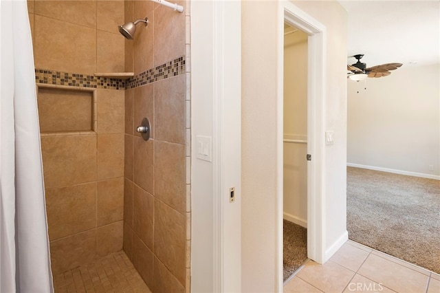 bathroom with ceiling fan, curtained shower, and tile patterned flooring