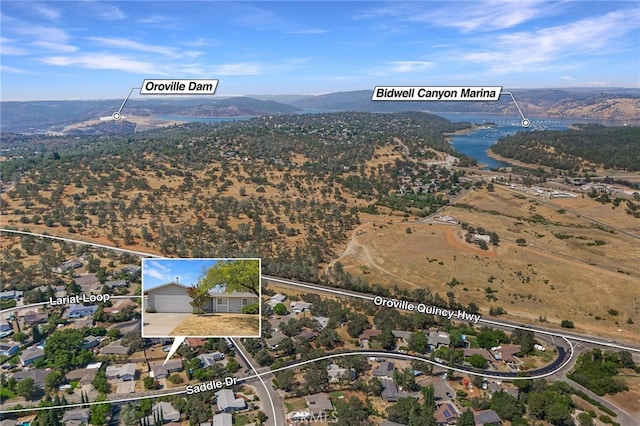 birds eye view of property featuring a water and mountain view