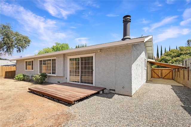 rear view of property with a wooden deck