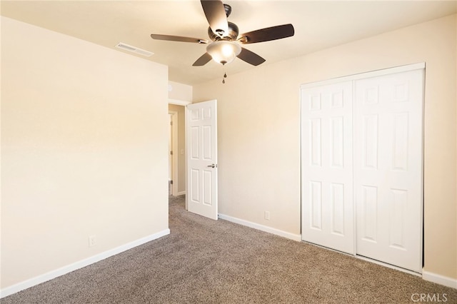 unfurnished bedroom with ceiling fan, a closet, and carpet