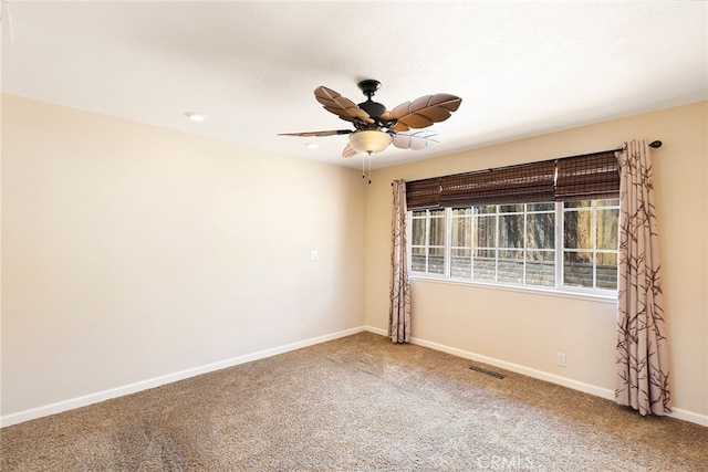 spare room featuring carpet floors and ceiling fan