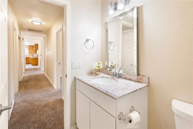 bathroom featuring toilet and vanity