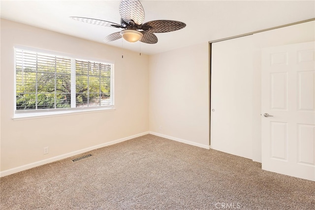 unfurnished bedroom featuring ceiling fan, carpet flooring, and a closet