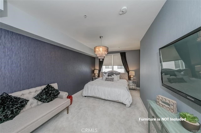 bedroom with carpet floors and an inviting chandelier