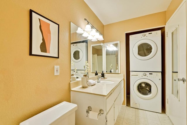 interior space featuring sink and stacked washer / dryer