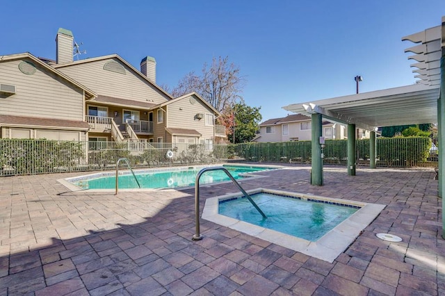 view of pool featuring a patio area and a hot tub